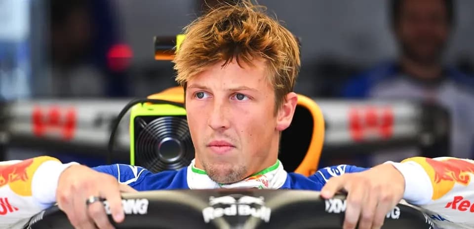 Driver seated in Formula 1 car cockpit during practice