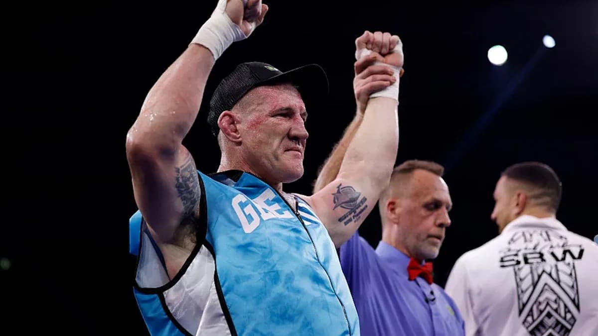 Boxer celebrating victory with raised hands in ring