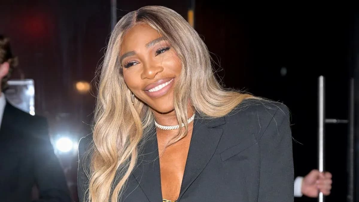 Woman smiling in a stylish black outfit