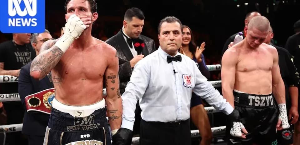 Boxers with referee after match in ring