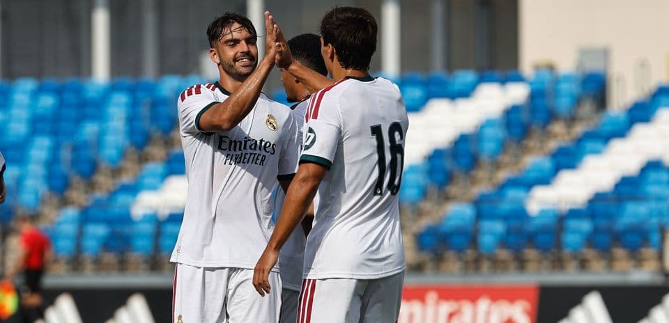 Real Madrid players celebrating a goal during training