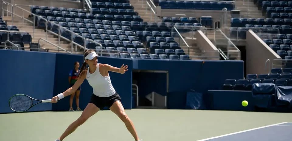 Female tennis player hitting a ball on court