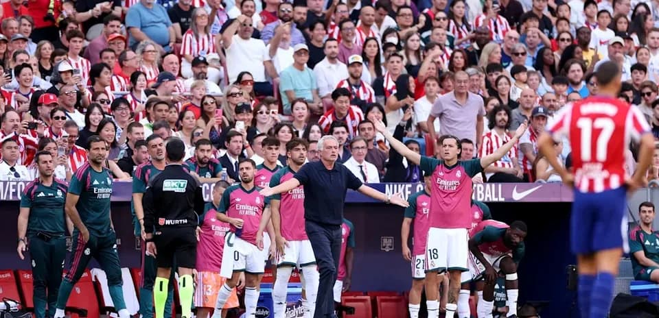 Coach directing players during a football match