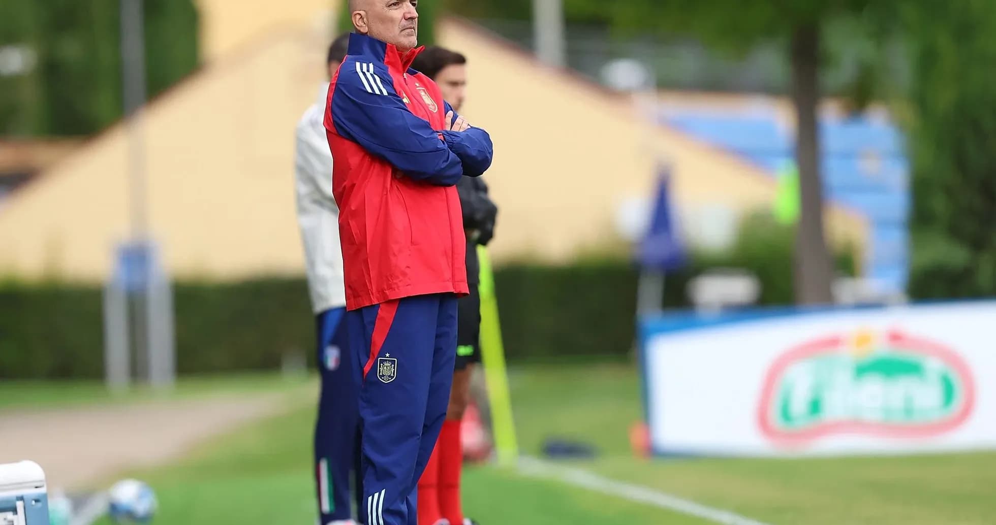 Coach observing players during training session