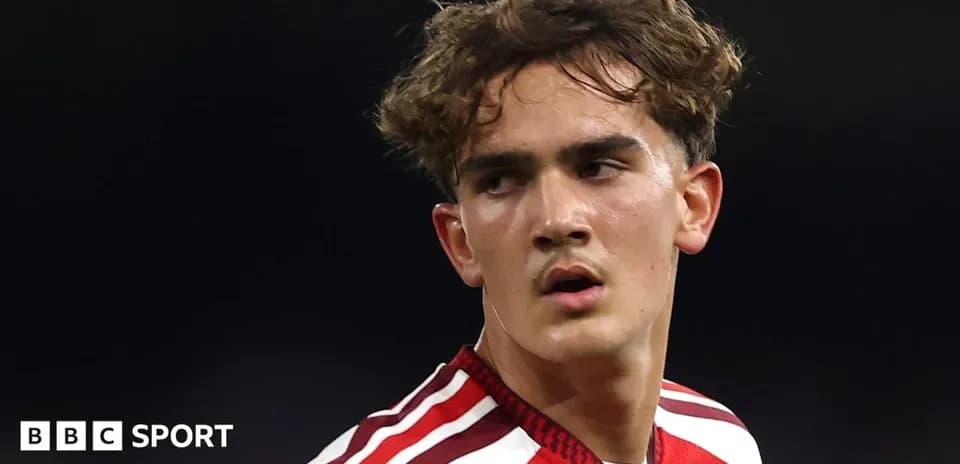 Football player in red kit during match
