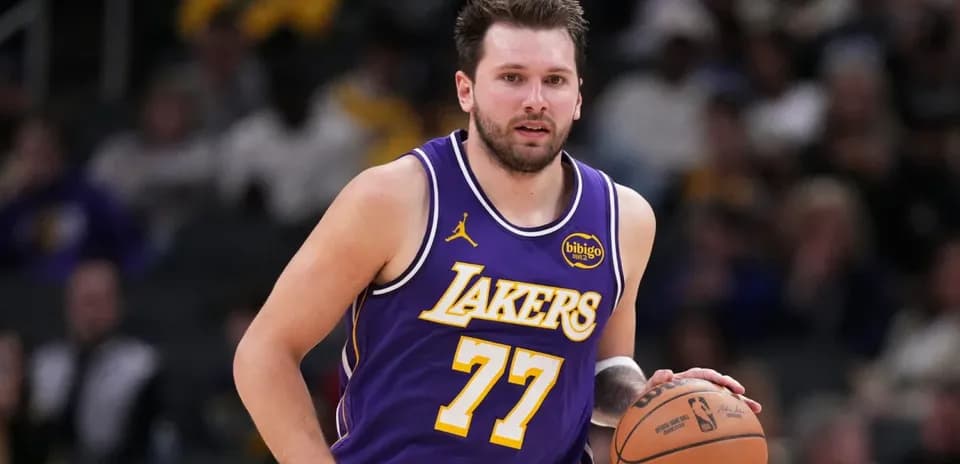 Player dribbling basketball during game for Lakers