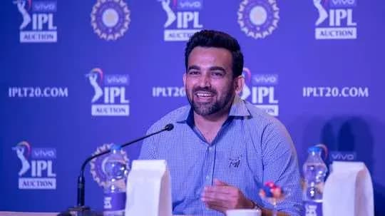 Speaker at IPL auction press conference smiling