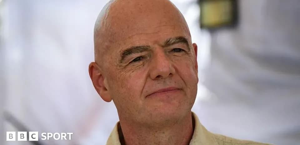 Man with bald head speaking at event