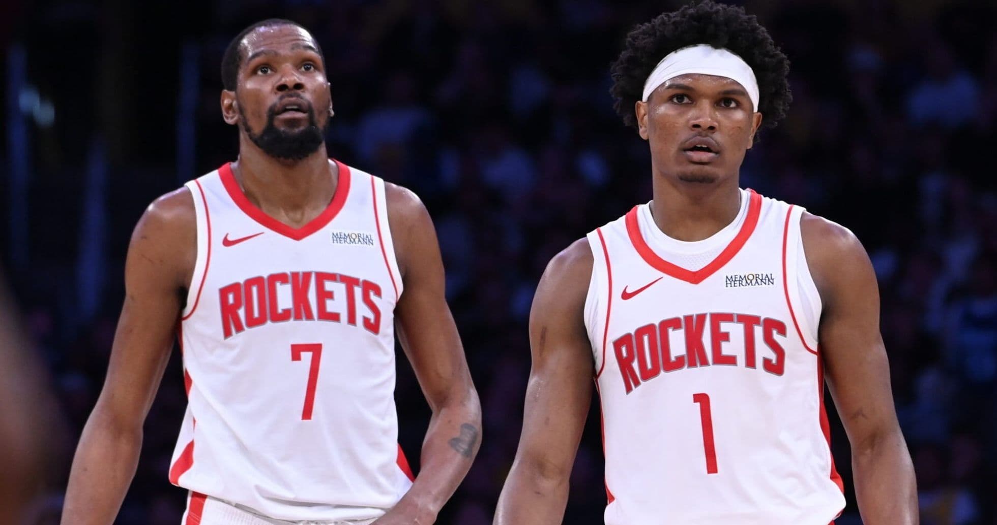 Two Houston Rockets players looking up during game