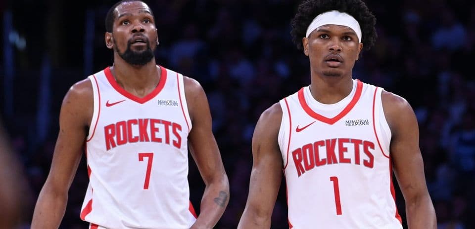 Two Houston Rockets players looking up during game