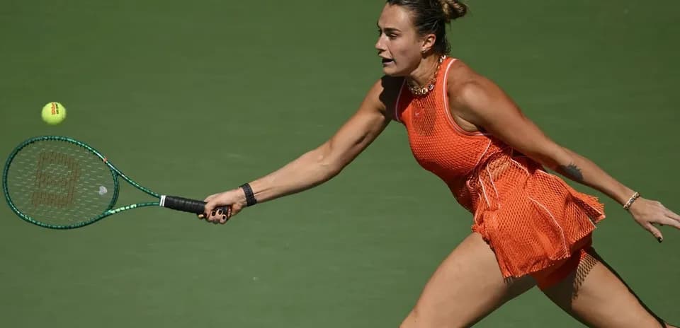 Female tennis player reaching for a flying ball