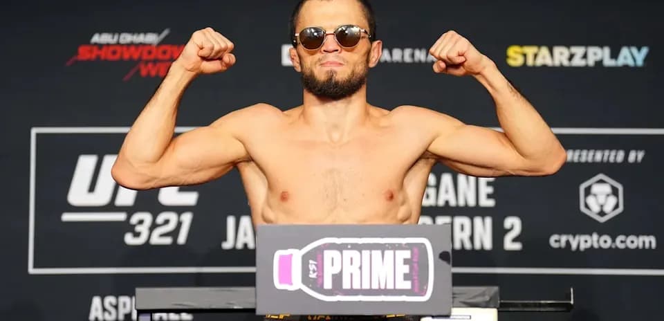 Fighter posing on scale at weigh-in event