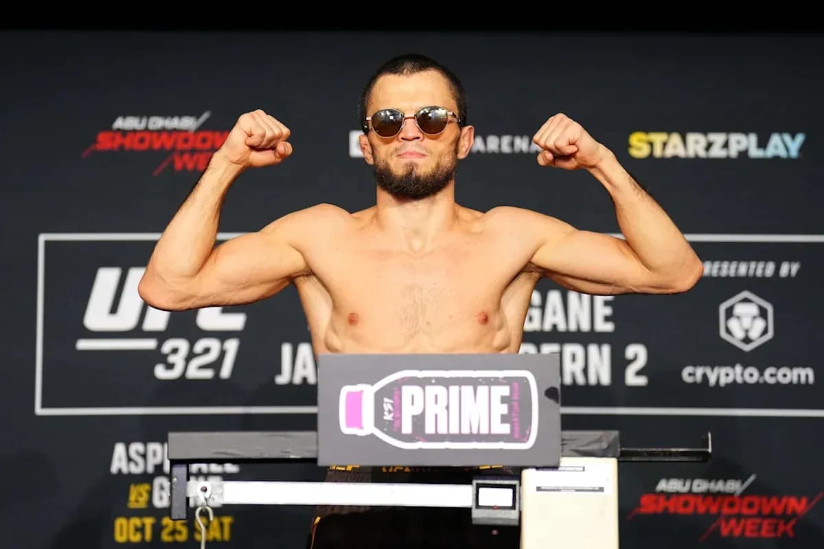 Fighter posing on scale at weigh-in event