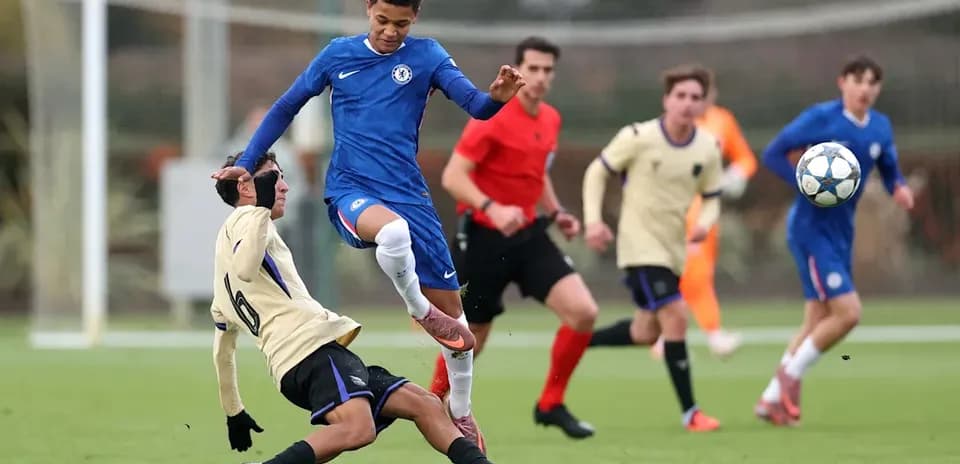 Player in blue jumping over opponent on the field