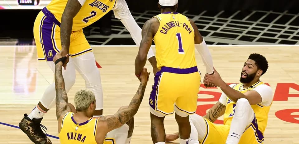 Lakers players helping each other after a play