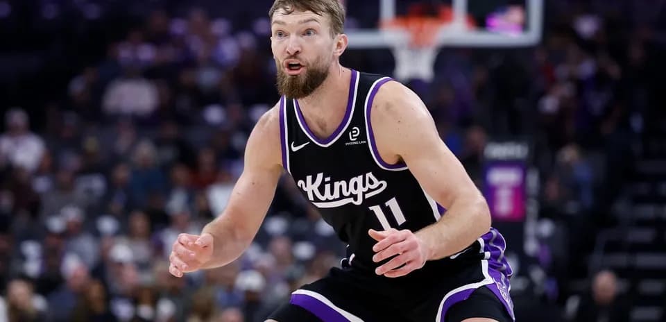 Player in black Kings uniform on defense during game
