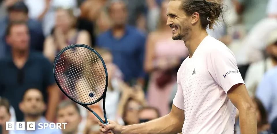Tennis player celebrating with racket in hand
