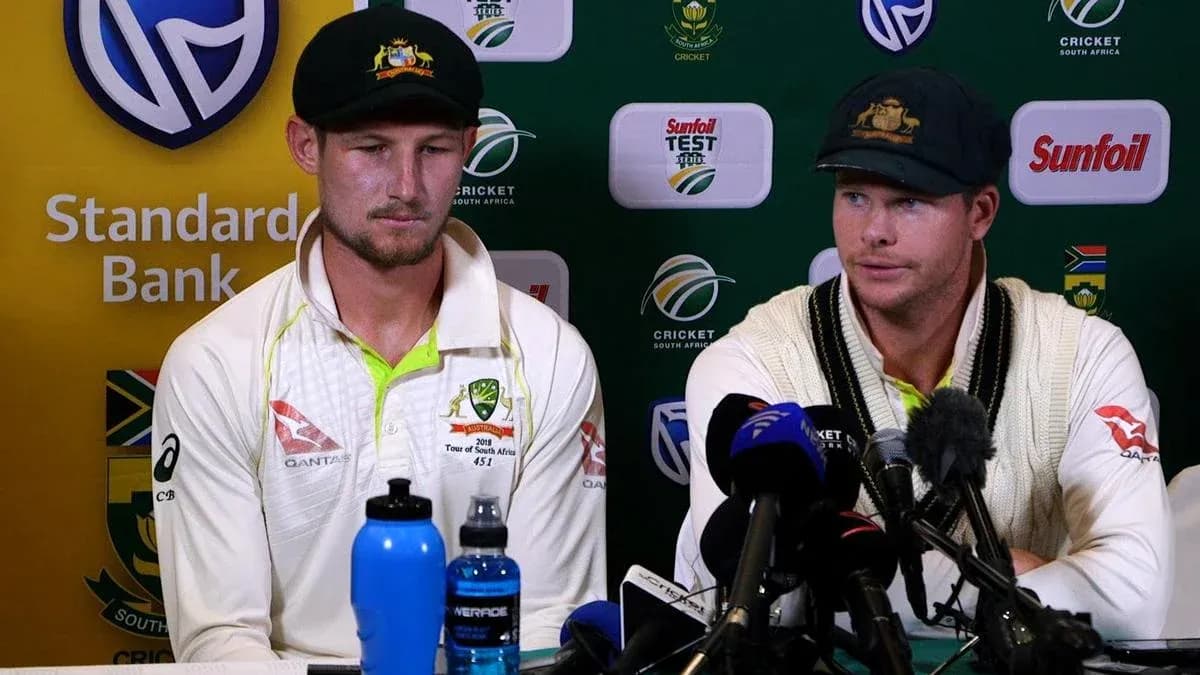 Cricketers at press conference with microphones and water bottles