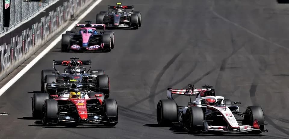 Four Formula 1 cars racing on track