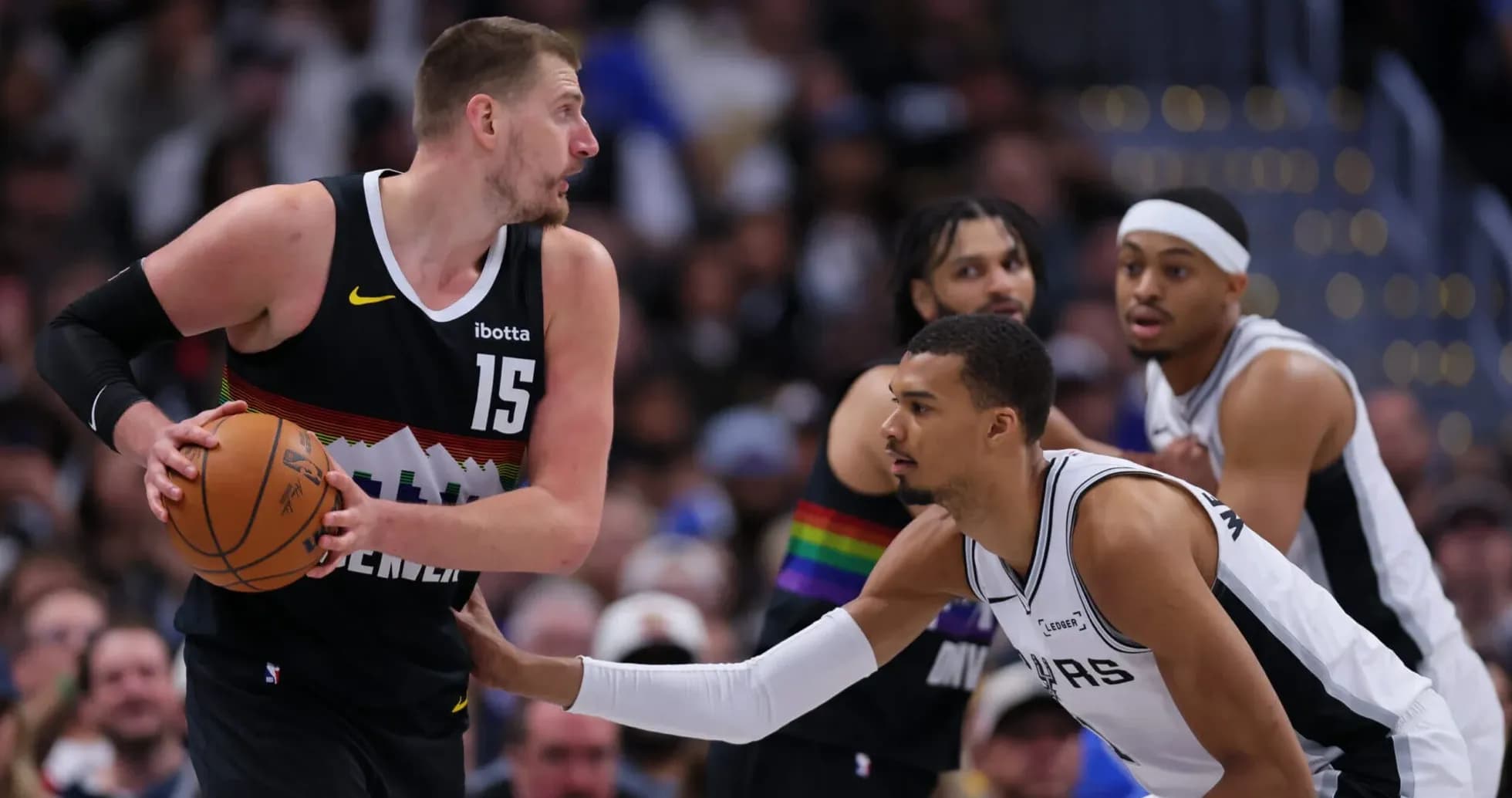 Player dribbling basketball while being guarded during game