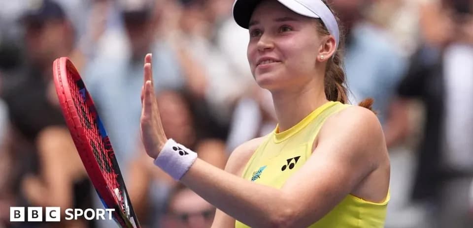 Tennis player waving to crowd after match