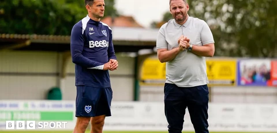 Two coaches discussing on training ground