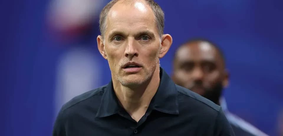 Coach looking focused during pre-match preparations