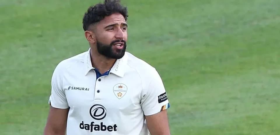 Cricketer in white kit during match action