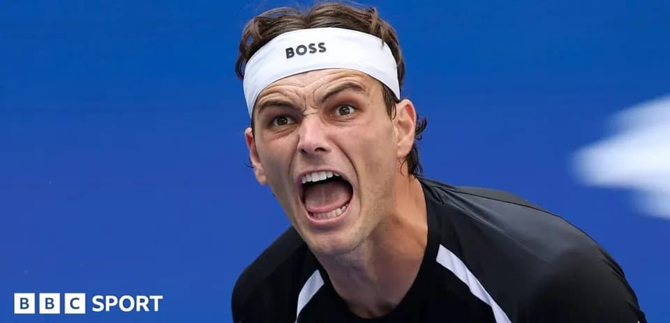 Tennis player celebrating during match with intense expression