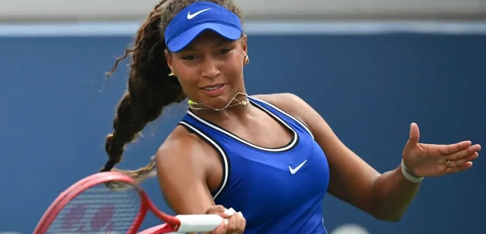 Tennis player hitting a backhand during match