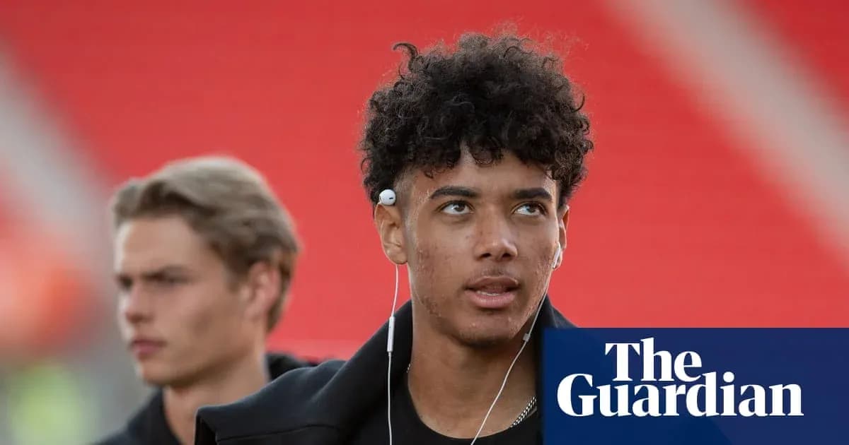 Young player with headphones walking in stadium