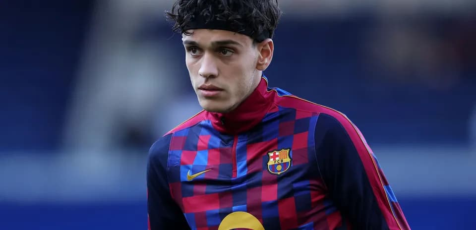 Player wearing FC Barcelona training kit on pitch