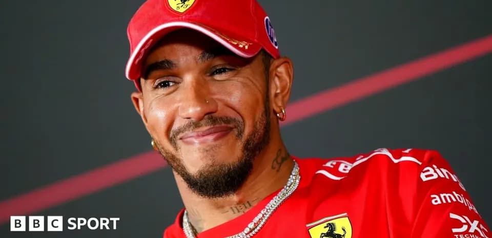 Driver smiling while wearing Ferrari team uniform