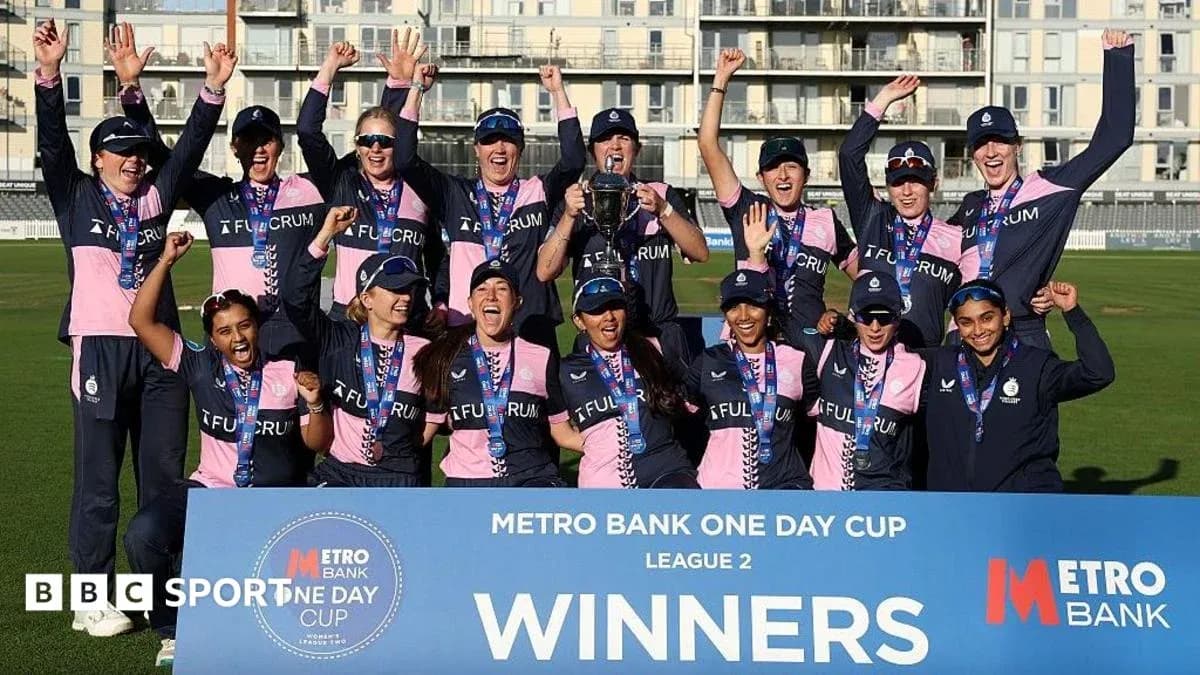 Cricket team celebrating victory with trophy and medals Cricket team celebrating victory with trophy and medals