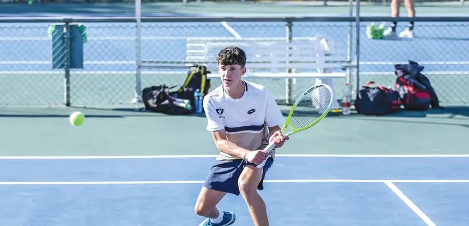 Young player preparing to hit a tennis ball