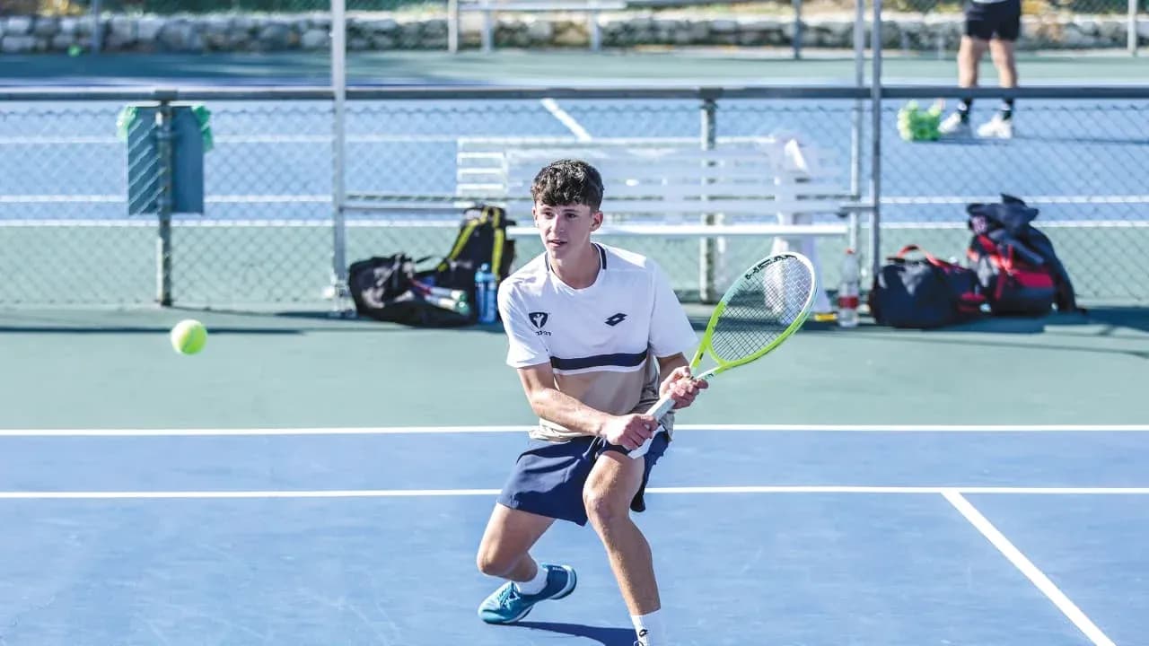 Young player preparing to hit a tennis ball