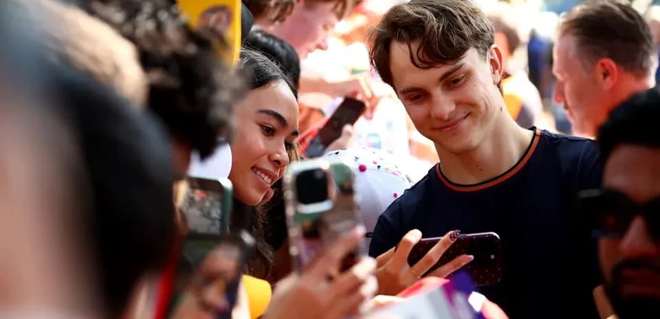 Fans taking selfie with a celebrity at event