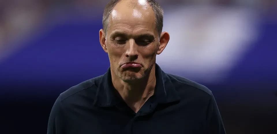Coach looking down during match commentary