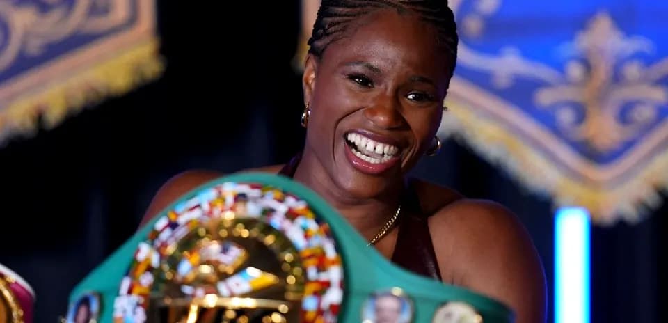 Boxer holding championship belt at event