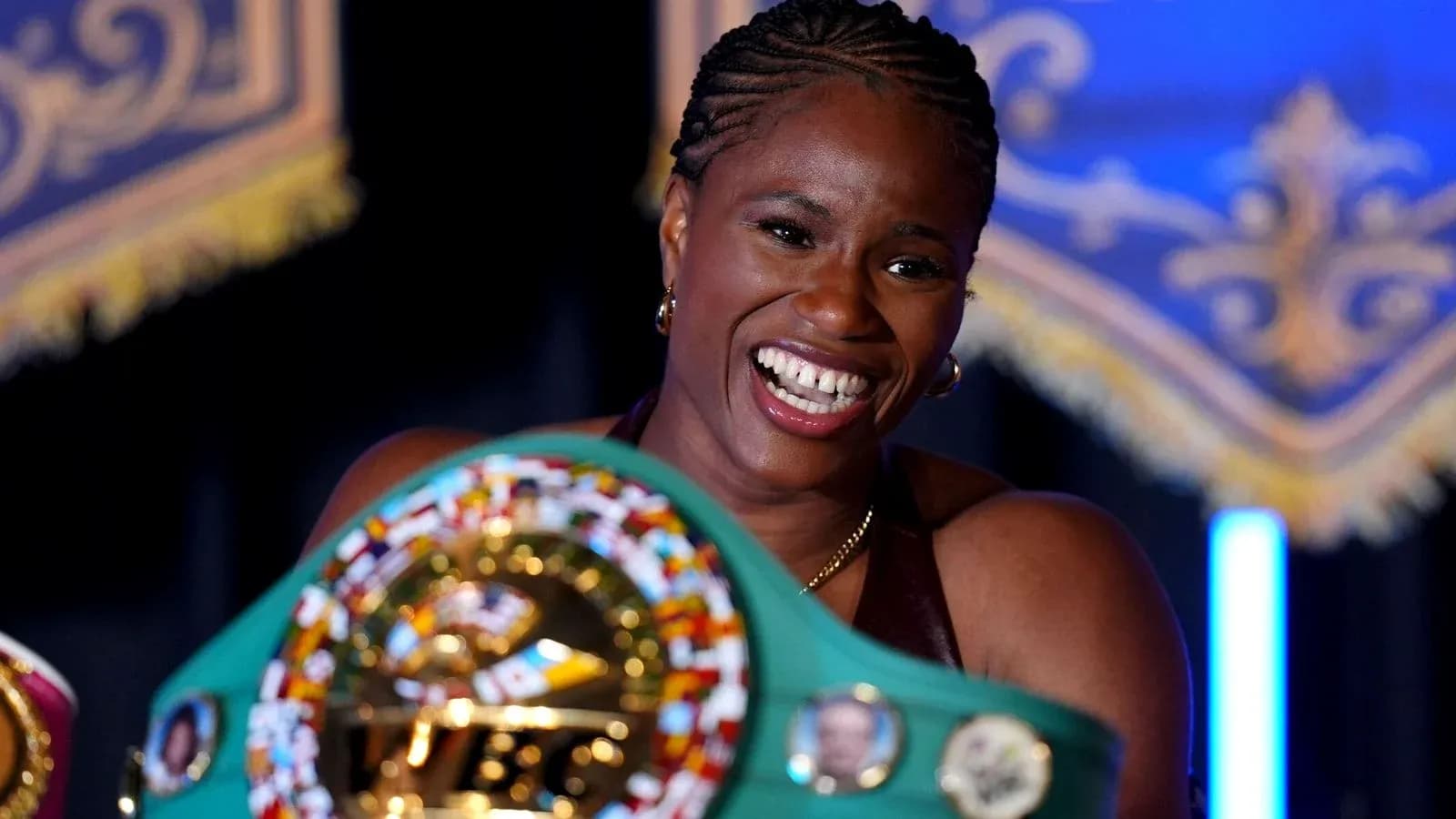 Boxer holding championship belt at event