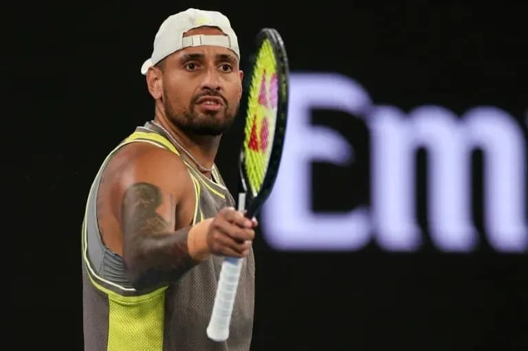 Tennis player holding racket during match action