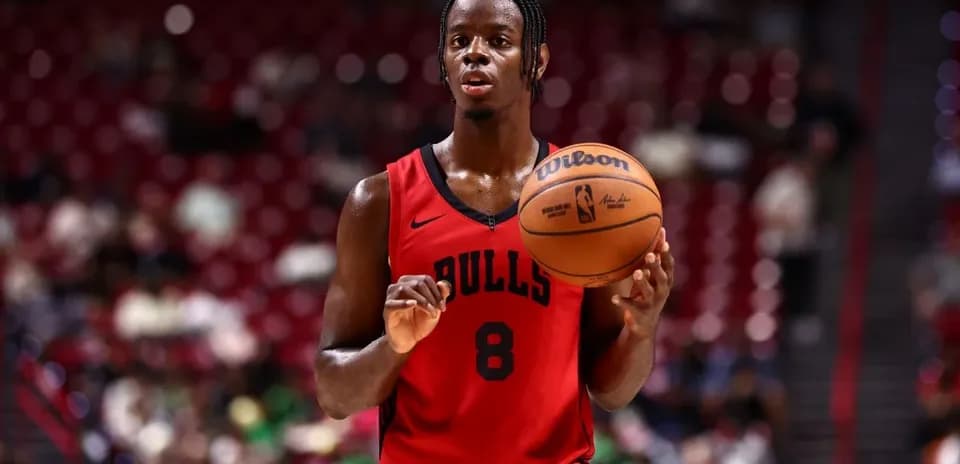 Player in red Bulls jersey holding basketball