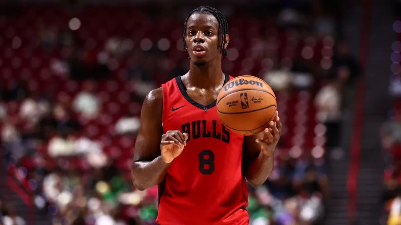 Player in red Bulls jersey holding basketball