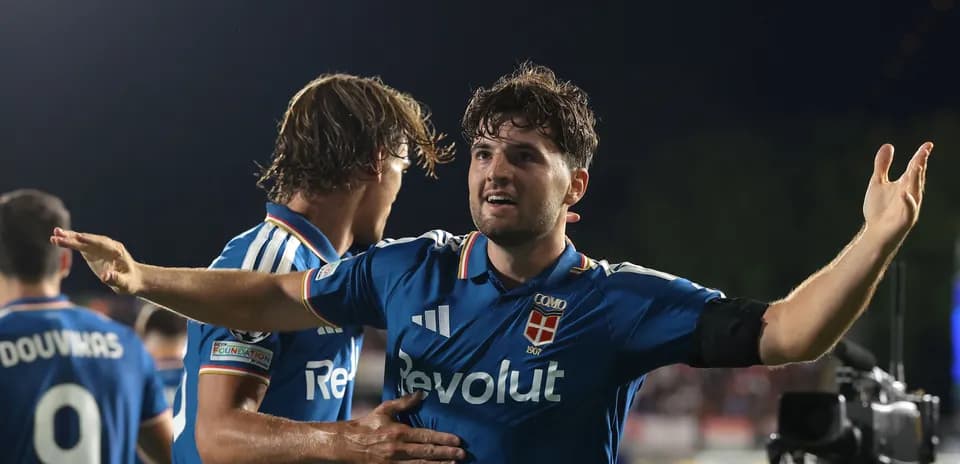 Player celebrating with teammates after scoring goal