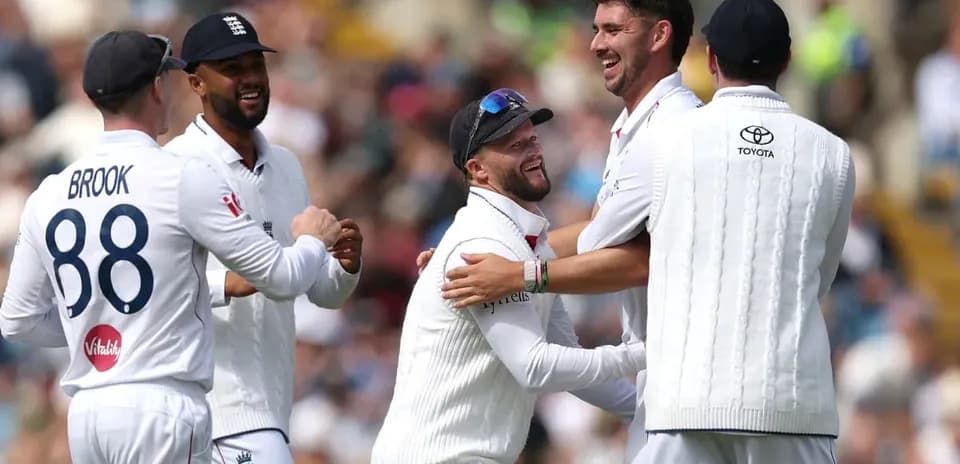 England players celebrating a wicket on the field