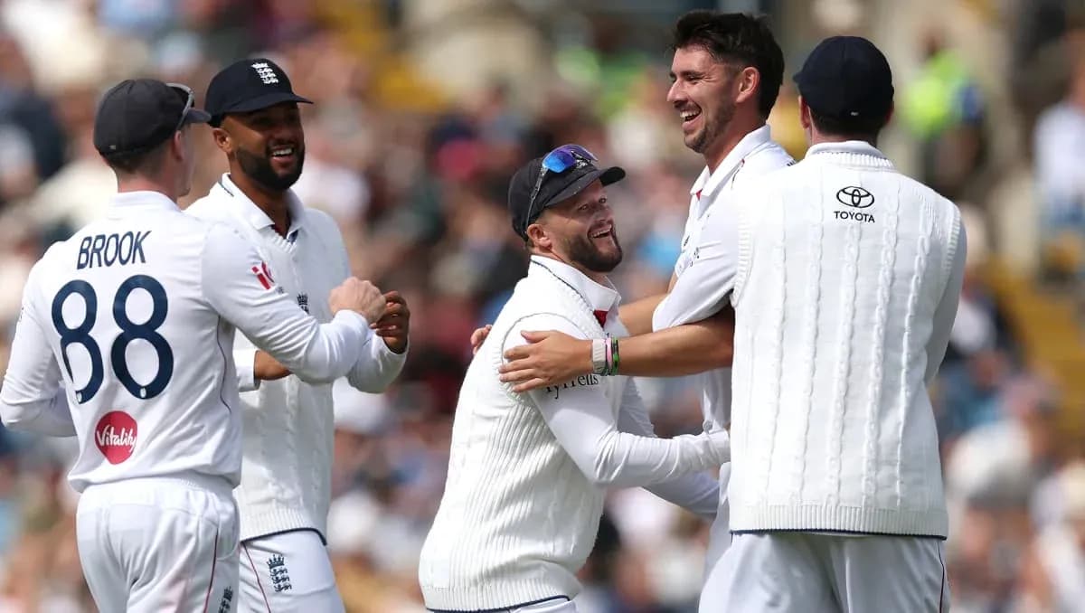 England players celebrating a wicket on the field