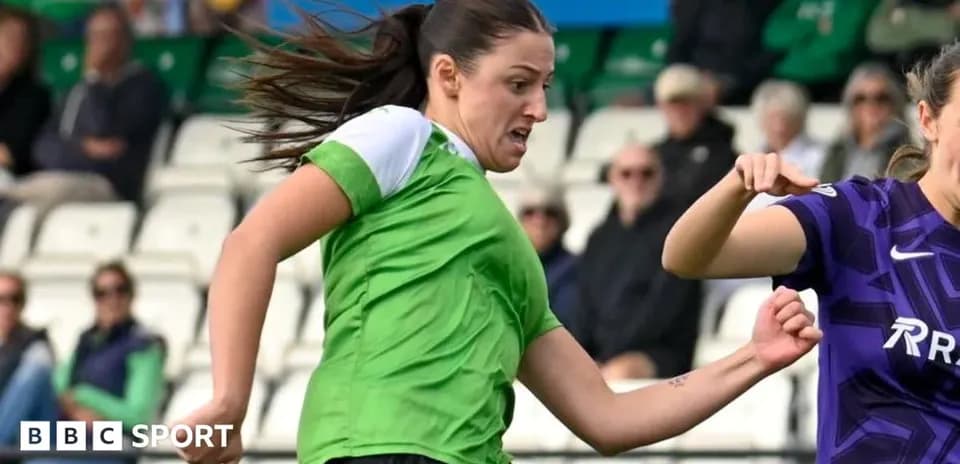 Player in green shirt dribbling past opponent