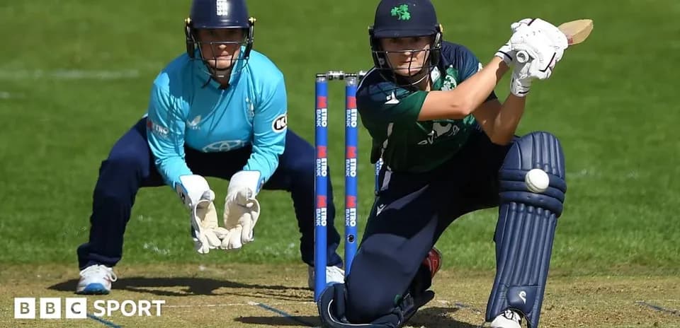 Batter playing a shot with wicketkeeper in position