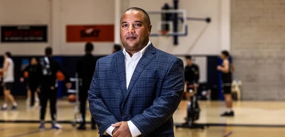 Coach posing on basketball court during practice