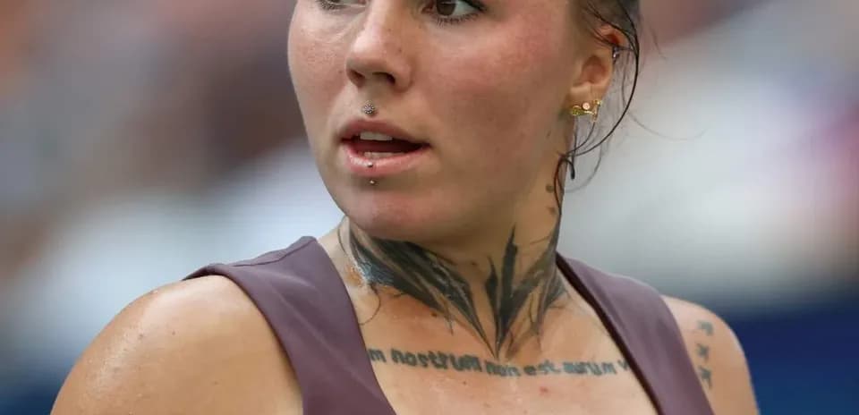 Athlete with tattoos and piercings during competition
